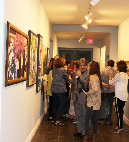 Crowd talking in gallery