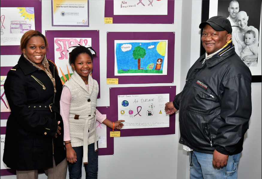 Proud family pointing to childs art