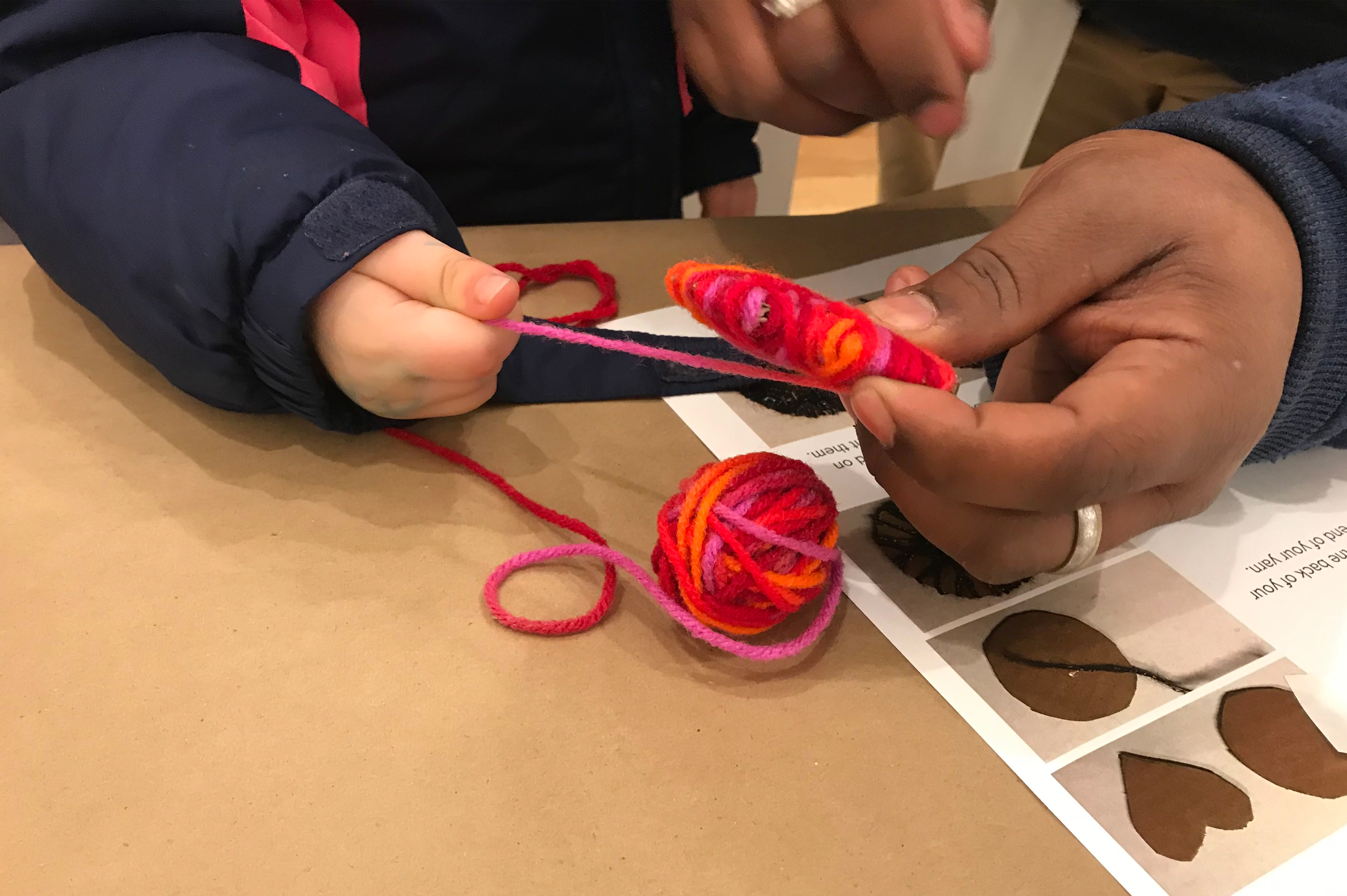 lobby monitor fire light and protest An adult helping a child with yarn.