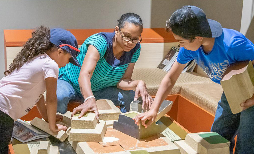 Family Plays with Pyramid Puzzle in Discover Ancient Egypt Exhibition. Family Plays with Pyramid Puzzle in Discover Ancient Egypt Exhibition.